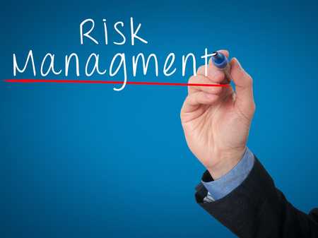 Businessman is writing Risk Management on the transparent board. Isolated on blue background. Stock Imageの写真素材