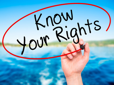 Man Hand writing Know Your Rights with black marker on visual screen. Isolated on nature. Business, technology, internet concept. Stock Imageの写真素材