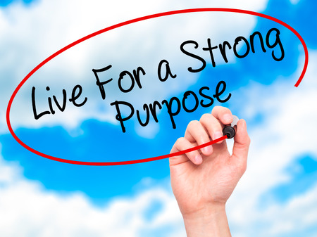 Man Hand writing Live For a Strong Purpose with black marker on visual screen. Isolated on sky. Business, technology, internet concept. Stock Photoの写真素材