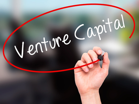 Man Hand writing Venture Capital with black marker on visual screen. Isolated on office. Business, technology, internet concept. Stock Photo Man Hand writing Venture Capital with black marker on visual screen. Isolated on office. Business, technology, internet concept. Stock Photo