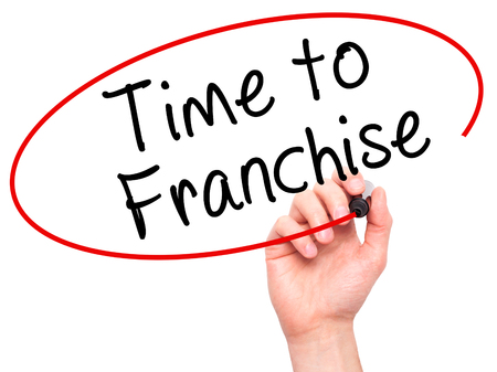 Man Hand writing Time to Franchise with black marker on visual screen. Isolated on white. Business, technology, internet concept. Stock Photo Man Hand writing Time to Franchise with black marker on visual screen. Isolated on white. Business, technology, internet concept. Stock Photo