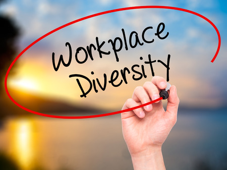 Man Hand writing Workplace Diversity  with black marker on visual screen. Isolated on background. Business, technology, internet concept. Stock Photoの写真素材
