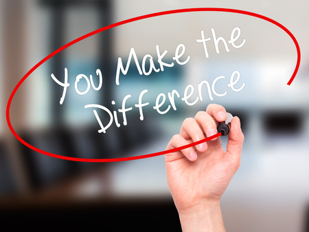 Man Hand writing You Make the Difference with black marker on visual screen. Isolated on office. Business, technology, internet concept. Stock Photoの写真素材