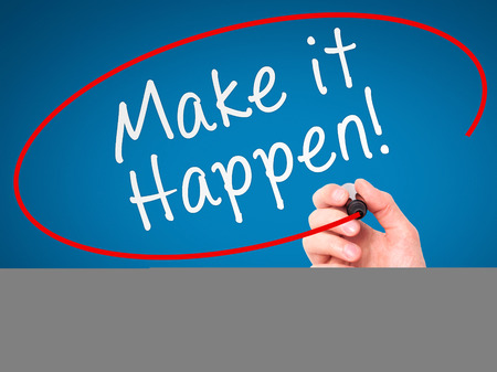 Man hand writing Make it happen! on visual screen. Business, internet, technology concept. Isolated on blue. Stock Photoの写真素材