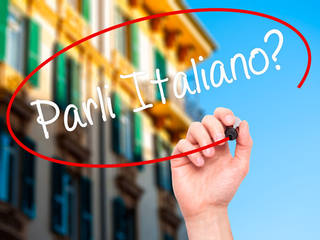 Man Hand writing Parli Italiano? with black marker on visual screen. Isolated on background. Business, technology, internet concept. Stock Photoの写真素材