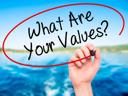 Man Hand writing What Are Your Values? with black marker on visual screen. Isolated on nature. Business, technology, internet concept. Stock Photoの写真素材