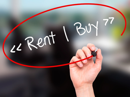 Man Hand writing Rent - Buy  with black marker on visual screen. Isolated on background. Business, technology, internet concept. Stock Photoの写真素材