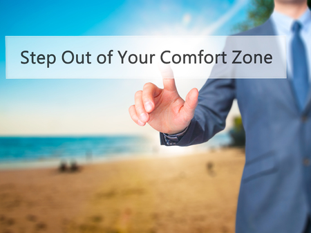 Step Out of Your Comfort Zone - Businessman hand pressing button on touch screen interface. Business, technology, internet concept. Stock Photoの写真素材
