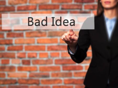 Bad Idea - Businesswoman hand pressing button on touch screen interface.の写真素材