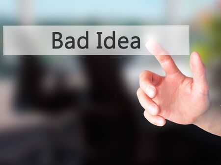 Bad Idea - Hand pressing a button on blurred background conceptの写真素材