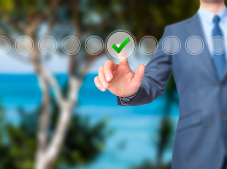 Businessman check mark on virtual screen. Finger on a checklist box and ticking. Business technology concept. Isolated on grey. Stock Imageの写真素材