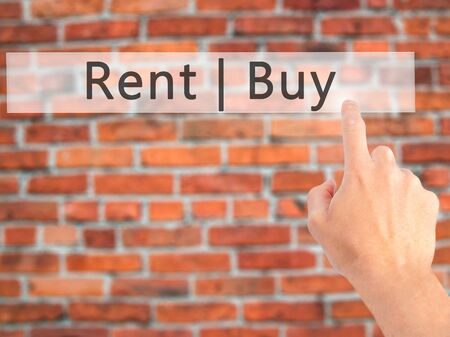 Rent Buy - Hand pressing a button on blurred background concept . Business, technology, internet concept. Stock Photoの写真素材