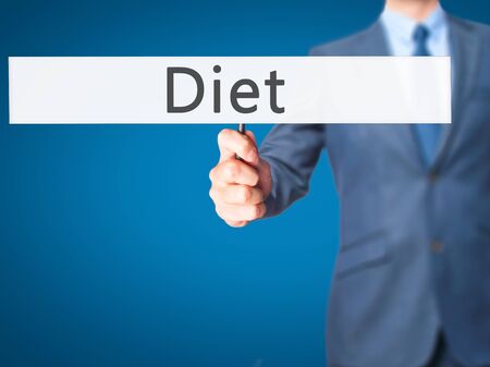 Diet - Businessman hand holding sign. Business, technology, internet concept. Stock Photoの写真素材