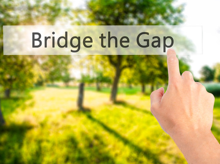Bridge the Gap - Hand pressing a button on blurred background concept . Business, technology, internet concept. Stock Photoの写真素材