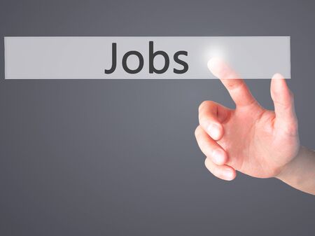 Jobs - Hand pressing a button on blurred background concept . Business, technology, internet concept. Stock Photoの写真素材