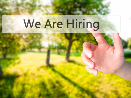 We Are Hiring - Hand pressing a button on blurred background concept . Business, technology, internet concept. Stock Photoの写真素材
