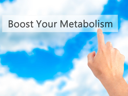 Boost Your Metabolism - Hand pressing a button on blurred background concept . Business, technology, internet concept. Stock Photoの写真素材