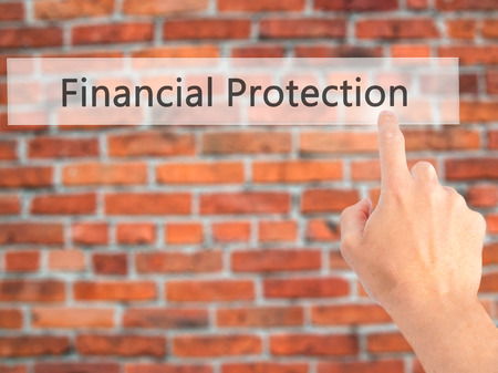 Financial Protection - Hand pressing a button on blurred background concept . Business, technology, internet concept. Stock Photo Financial Protection - Hand pressing a button on blurred background concept . Business, technology, internet concept. Stock Photo