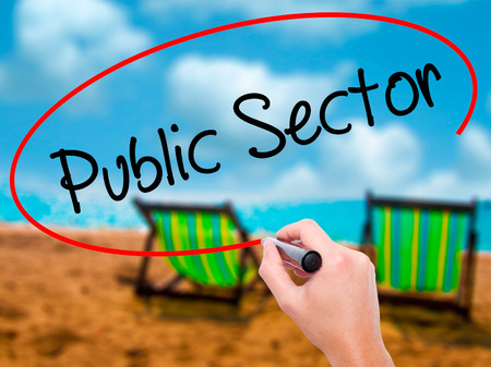 Man Hand writing Public Setor with black marker on visual screen. Isolated on sunbed on the beach. Business, technology, internet concept. Stock Photo Man Hand writing Public Setor with black marker on visual screen. Isolated on sunbed on the beach. Business, technology, internet concept. Stock Photo