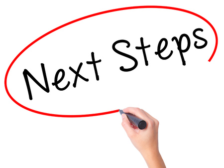Women Hand writing Next Steps with black marker on visual screen. Isolated on white. Business, technology, internet concept. Stock Imageの写真素材