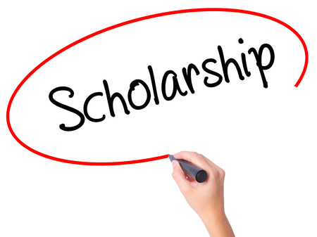 Women Hand writing Scholarship with black marker on visual screen. Isolated on white. Business, technology, internet concept. Stock Photoの写真素材