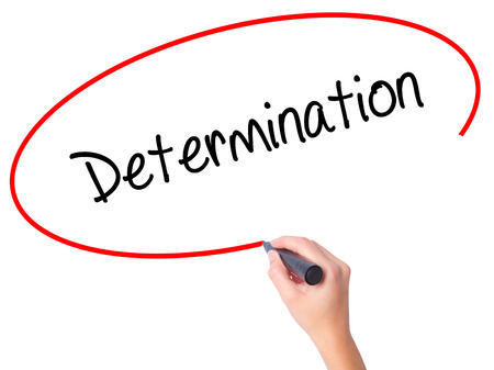 Women Hand writing Determination  with black marker on visual screen. Isolated on white. Business, technology, internet concept. Stock Photoの写真素材