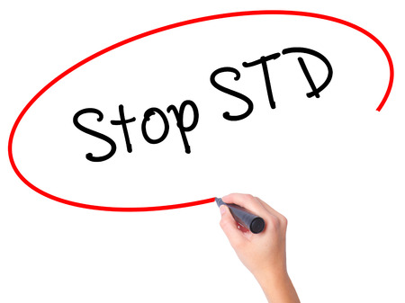 Women Hand writing Stop STD (Sexually transmitted diseases) with black marker on visual screen. Isolated on white. Business, technology, internet concept. Stock Photoの写真素材