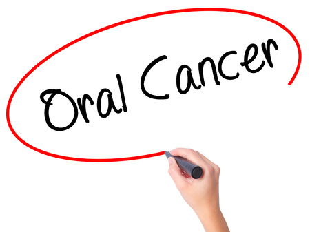 Women Hand writing Oral Cancer  with black marker on visual screen. Isolated on white. Business, technology, internet concept. Stock Photoの写真素材