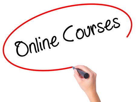 Women Hand writing Online Courses with black marker on visual screen. Isolated on white. Business, technology, internet concept. Stock Photoの写真素材