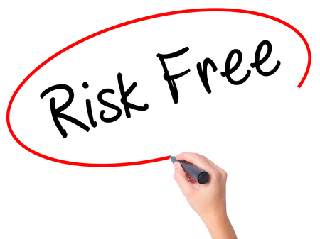 Women Hand writing Risk Free with black marker on visual screen. Isolated on white. Business, technology, internet concept. Stock Imageの写真素材