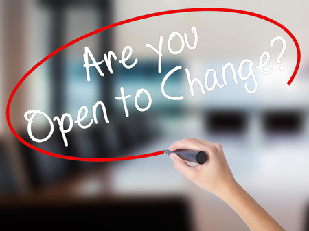 Woman Hand Writing Are you Open to Change? with a marker over transparent board. Isolated on Office. Business concept. Stock Photoの写真素材