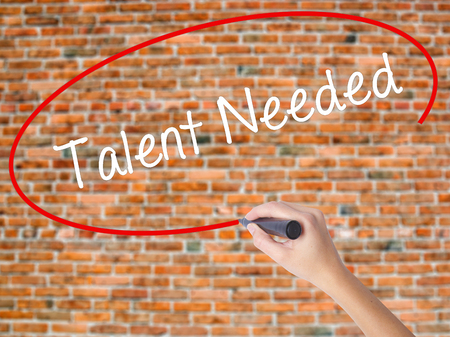 Woman Hand Writing Talent Needed with black marker on visual screen. Isolated on bricks. Business, technology, internet concept.の写真素材