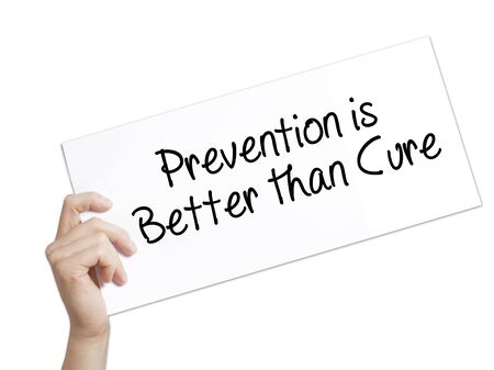 Prevention is Better than Cure Sign on white paper. Man Hand Holding Paper with text. Isolated on white background.  Business concept. Stock Photoの写真素材