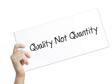 Quality Not Quantity Sign on white paper. Man Hand Holding Paper with text. Isolated on white background.   Business concept. Stock Photoの写真素材