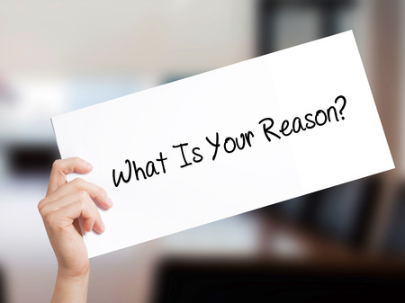 What Is Your Reason? Sign on white paper. Man Hand Holding Paper with text. Isolated on Office background.  Business concept. Stock Photoの写真素材