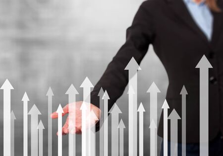 Businesswoman with financial symbols coming. Business, growth, investment concept. Women hand showing arrows. Isolated on grey. Stock Imageの写真素材