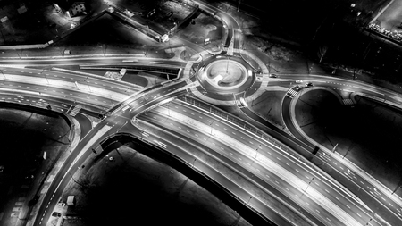 Urban Night traffic junction road with light of vehicle movement aerial view from drone