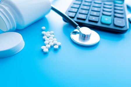 pills and medicines under a magnifying glass next to a medical stethoscope. The concept of health and responsible use of medicines, vitamins and various supplementsの写真素材