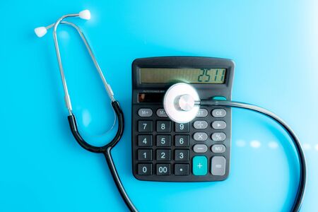 Health care costs. Stethoscope and calculator symbol for health care costs or medical insuranceの写真素材