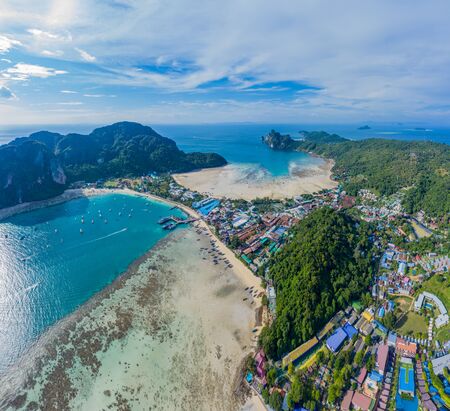 Aerial view of Phi Phi, Maya beach with blue turquoise seawater, mountain hills, and tropical green forest trees at sunset with Andaman sea in Phuket island in summer, Thailand in travel trip. Nature. Panoramaの写真素材