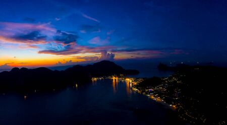 Aerial view of Phi Phi, Maya beach with blue turquoise seawater, mountain hills, and tropical green forest trees at sunset with Andaman sea in Phuket island in summer, Thailand in travel trip. Nature.の写真素材