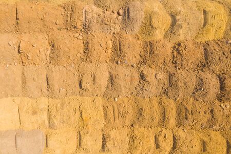 Top view on a sand quarry. Arial view on a mining of natural resources or ore. Green river separates...