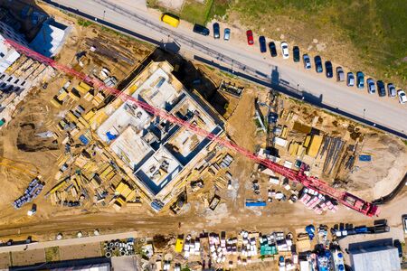 Construction site with cranes. Construction workers are building. Aerial view of construction site of residential area buildings with cranesの写真素材