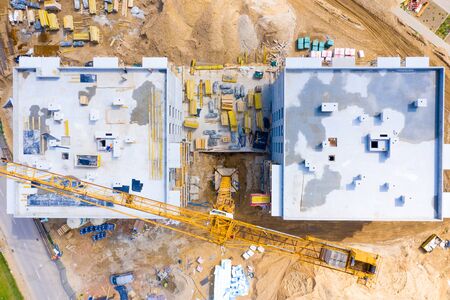 Construction site with cranes. Construction workers are building. Aerial view apartment building...
