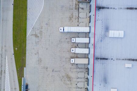 Aerial view of goods warehouse. Logistics center in industrial city zone from above. Aerial view of...