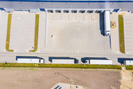 Aerial view of goods warehouse. Logistics center in industrial city zone from above. Aerial view of...