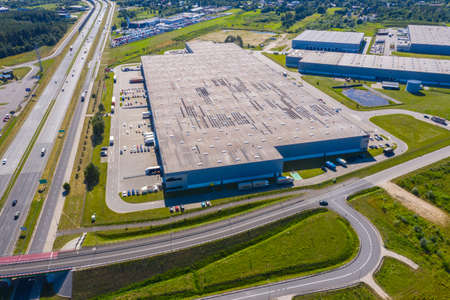 Aerial Shot of Industrial Loading Area where Many Trucks Are Unloading Merchandise.の写真素材