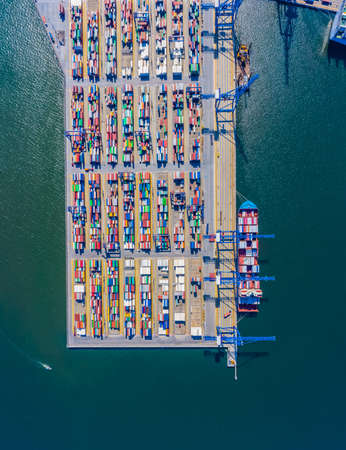 Container ship in export and import business and logistics. Shipping cargo to harbor by crane. Water transport International. Aerial view and top view.の写真素材