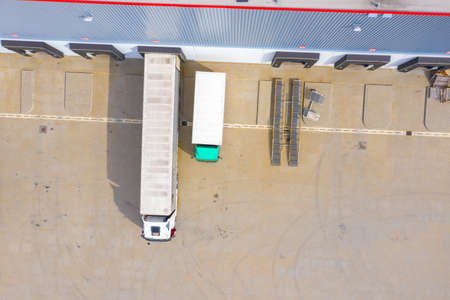 Aerial view of goods warehouse. Logistics center in industrial city zone from above. Aerial view of...