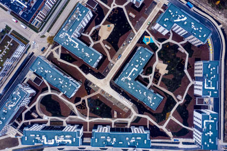 Urban texture and pattern. Aerial view of the city buildings under a cloudy sky.